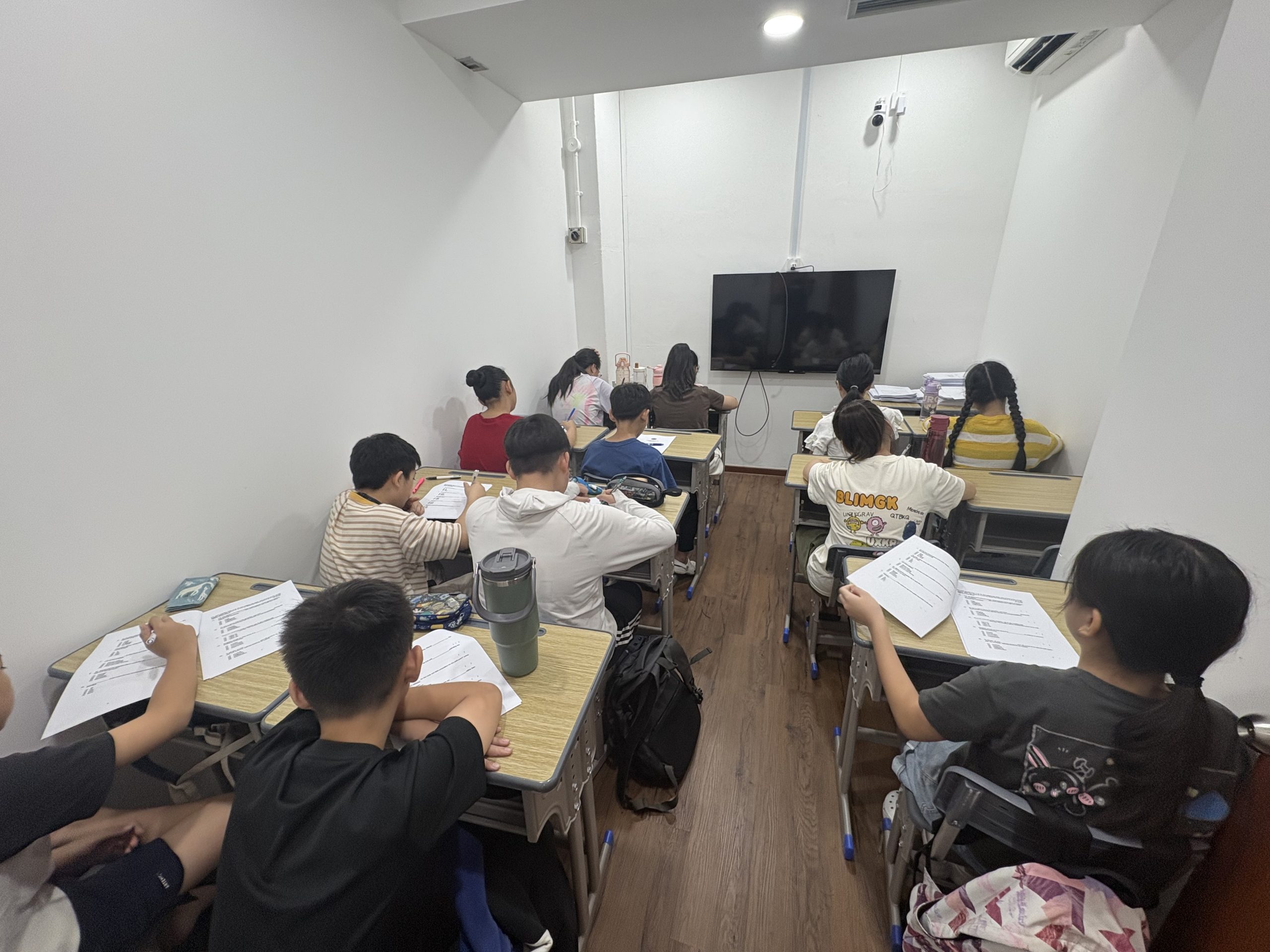 Photo of students studying during a holiday camp at Oxkids Woodlands centre