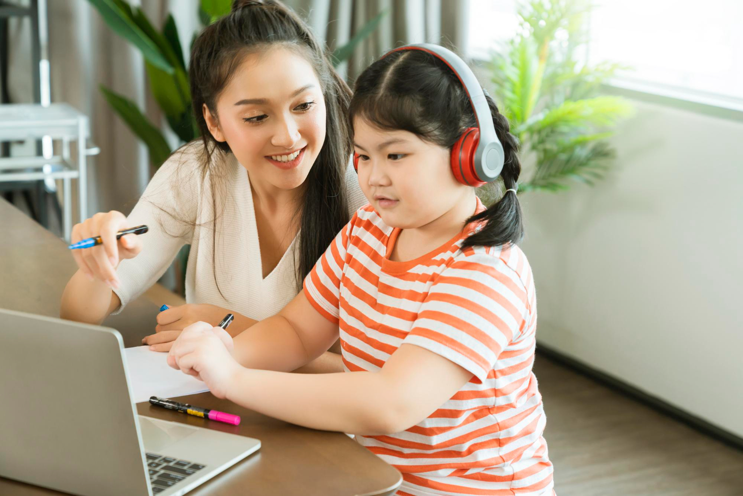 Mother and child learning through online class