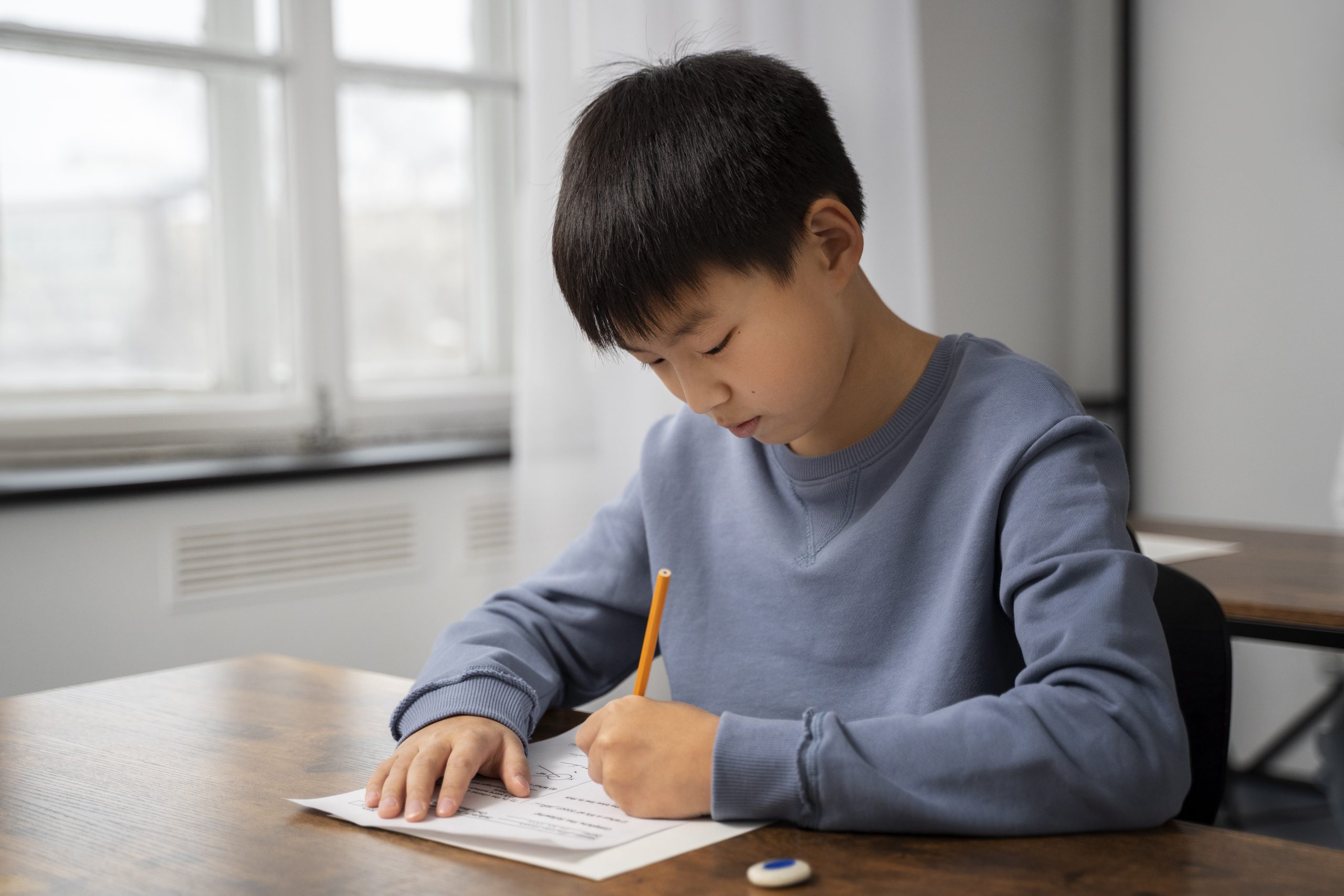 Image of child studying and taking test paper